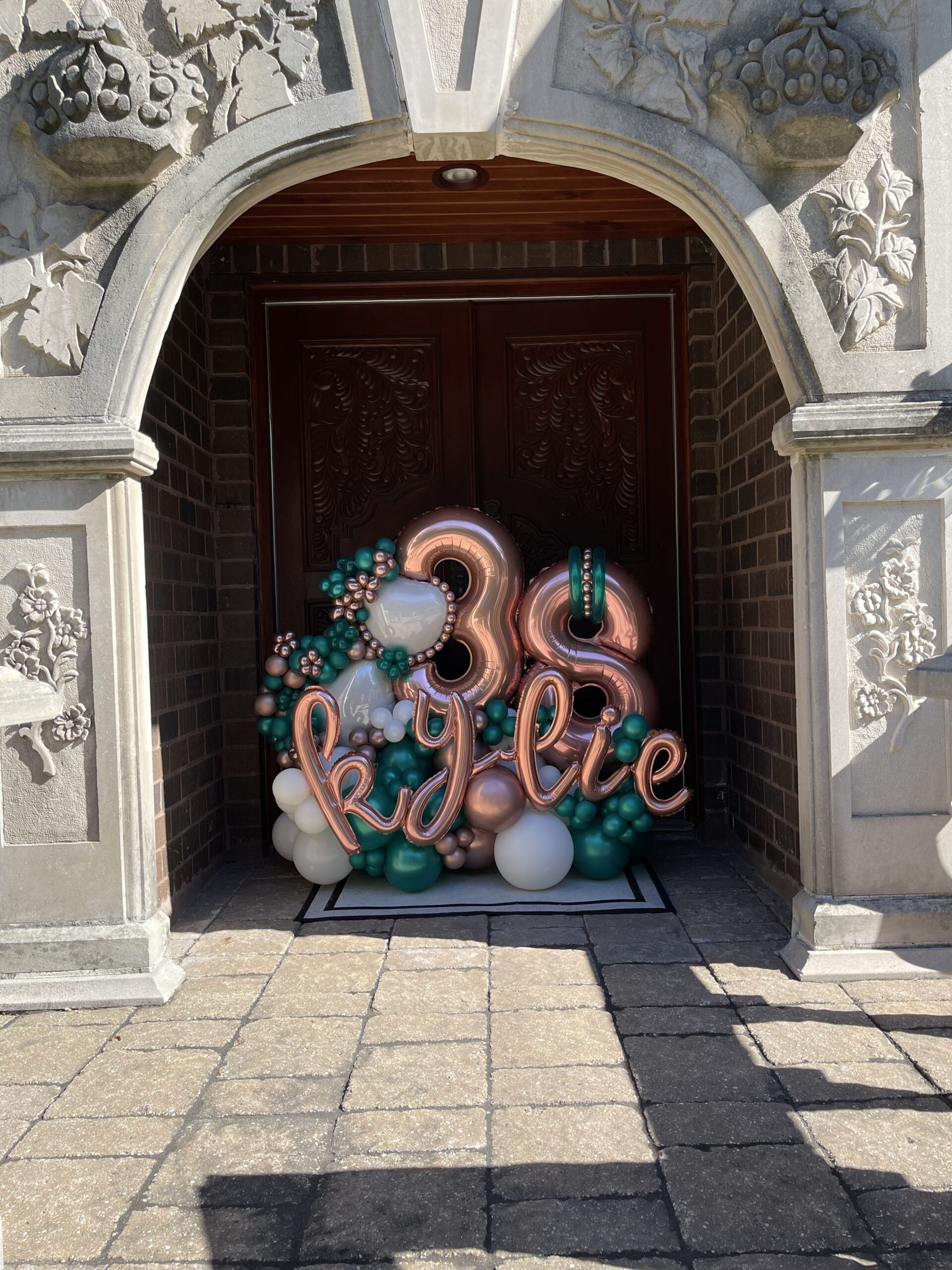A birthday balloon display in someone's doorway.